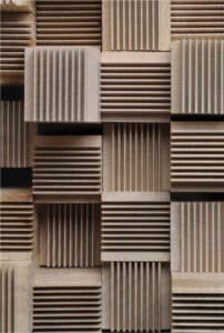 Wooden blocks with vertical and horizontal grooves.